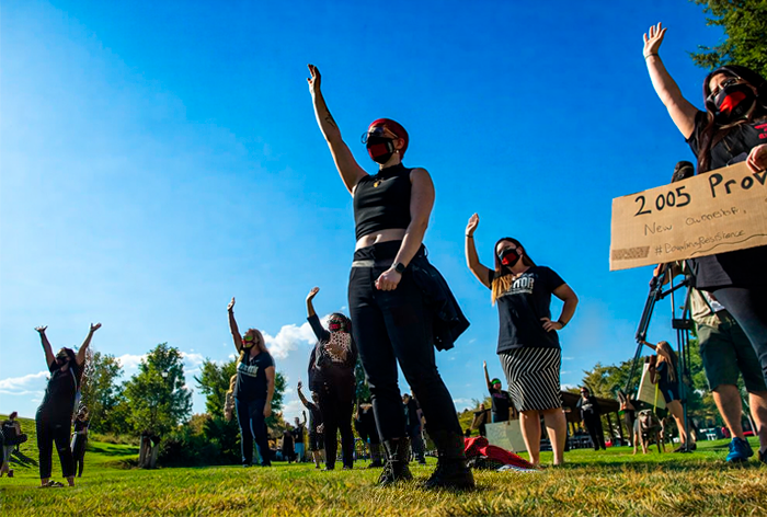 Survivors raise their hands in response to Jen Robison's question at Provo Rally