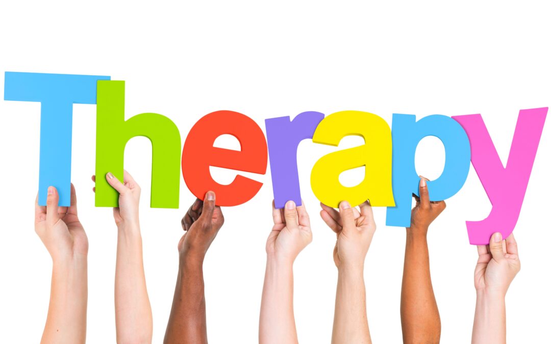 Hands holding letters that spell 'Therapy'